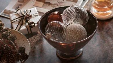 a table with a bowl of fruit and a box of gifts