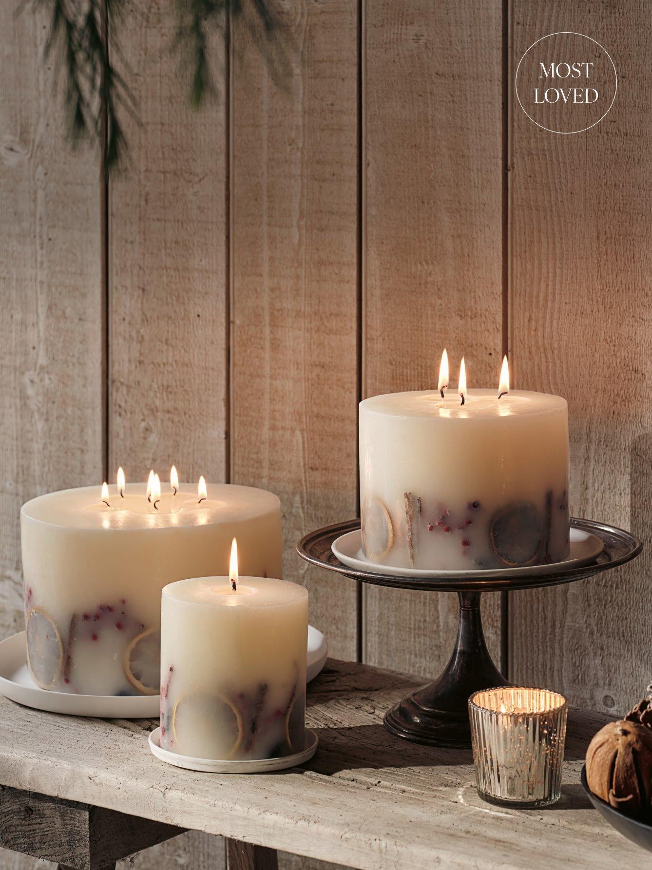 a table with three candles on it and a plate of food