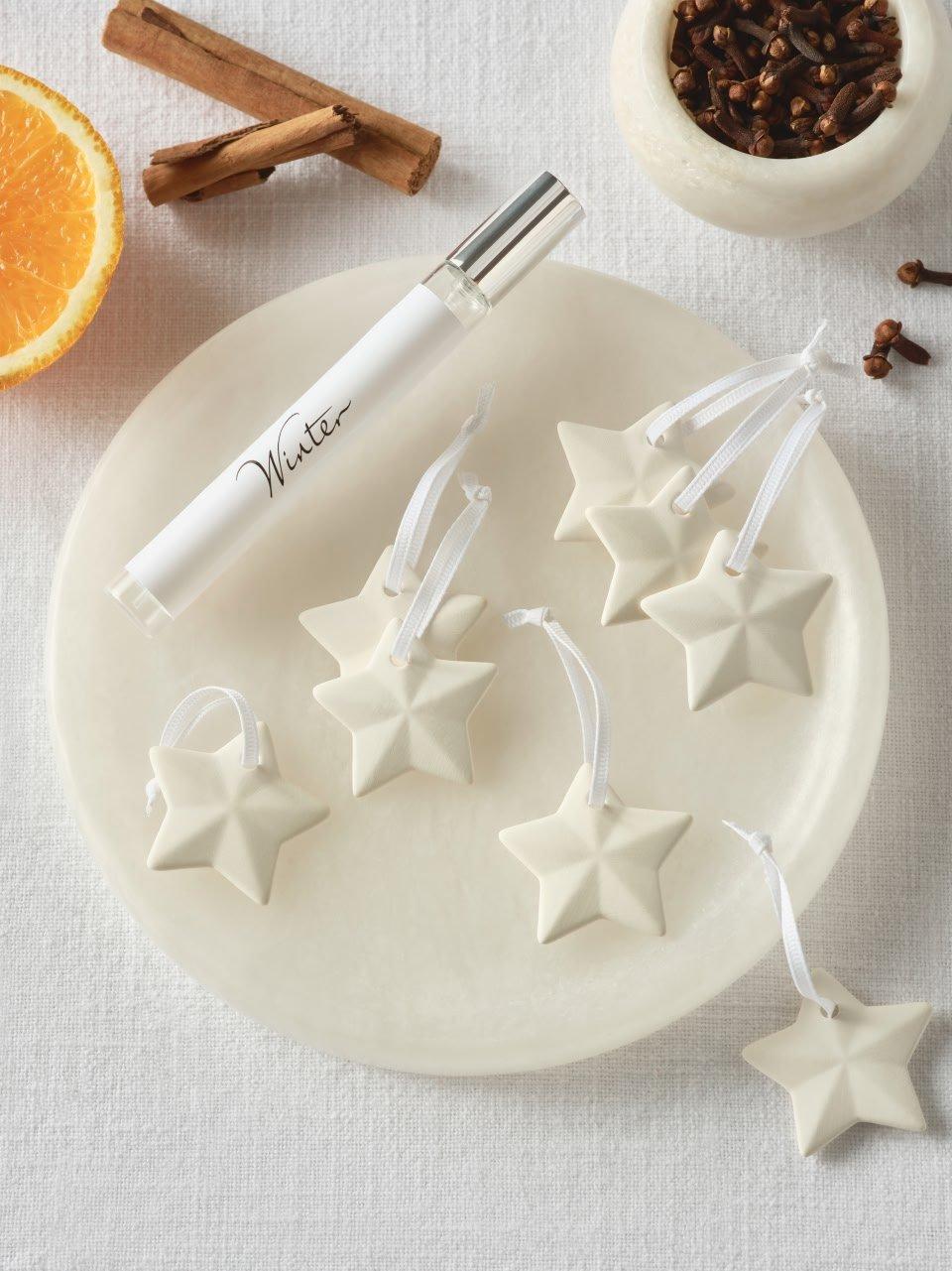 a plate with a cinnamon stick and a star shaped candle