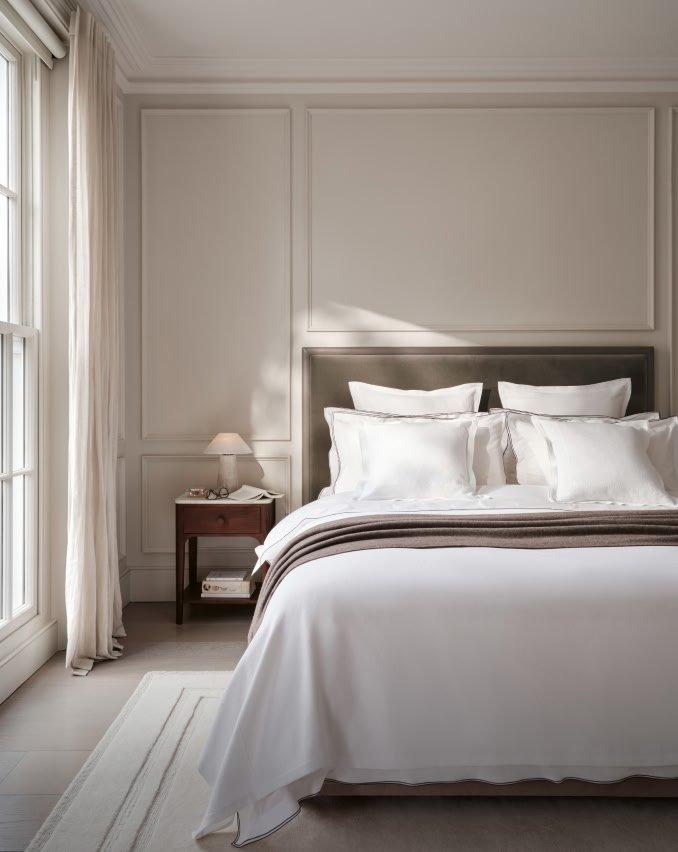 a bedroom with a large bed and a window with a view
