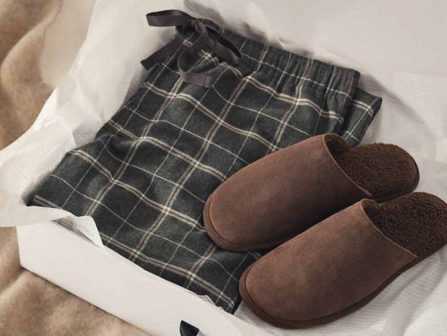 a pair of slippers and a pair of pants in a box
