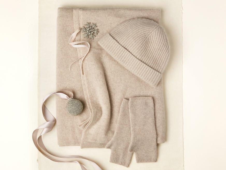 a white hat, gloves, scarf and a snowflake are displayed