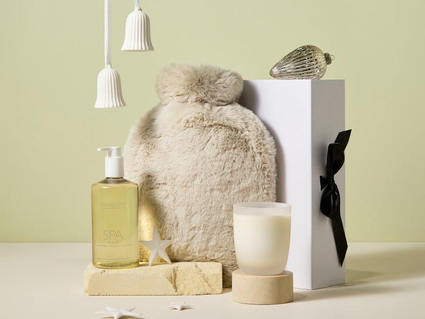 a gift set with a candle, a hot water bottle and a candle holder