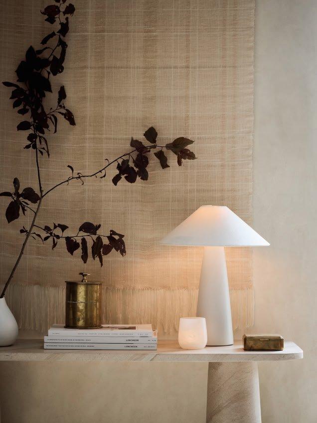 a table with a lamp and a vase on it