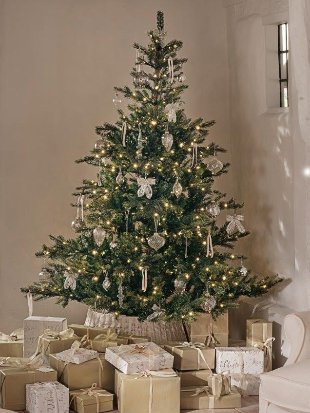 a christmas tree is in a room with presents under it