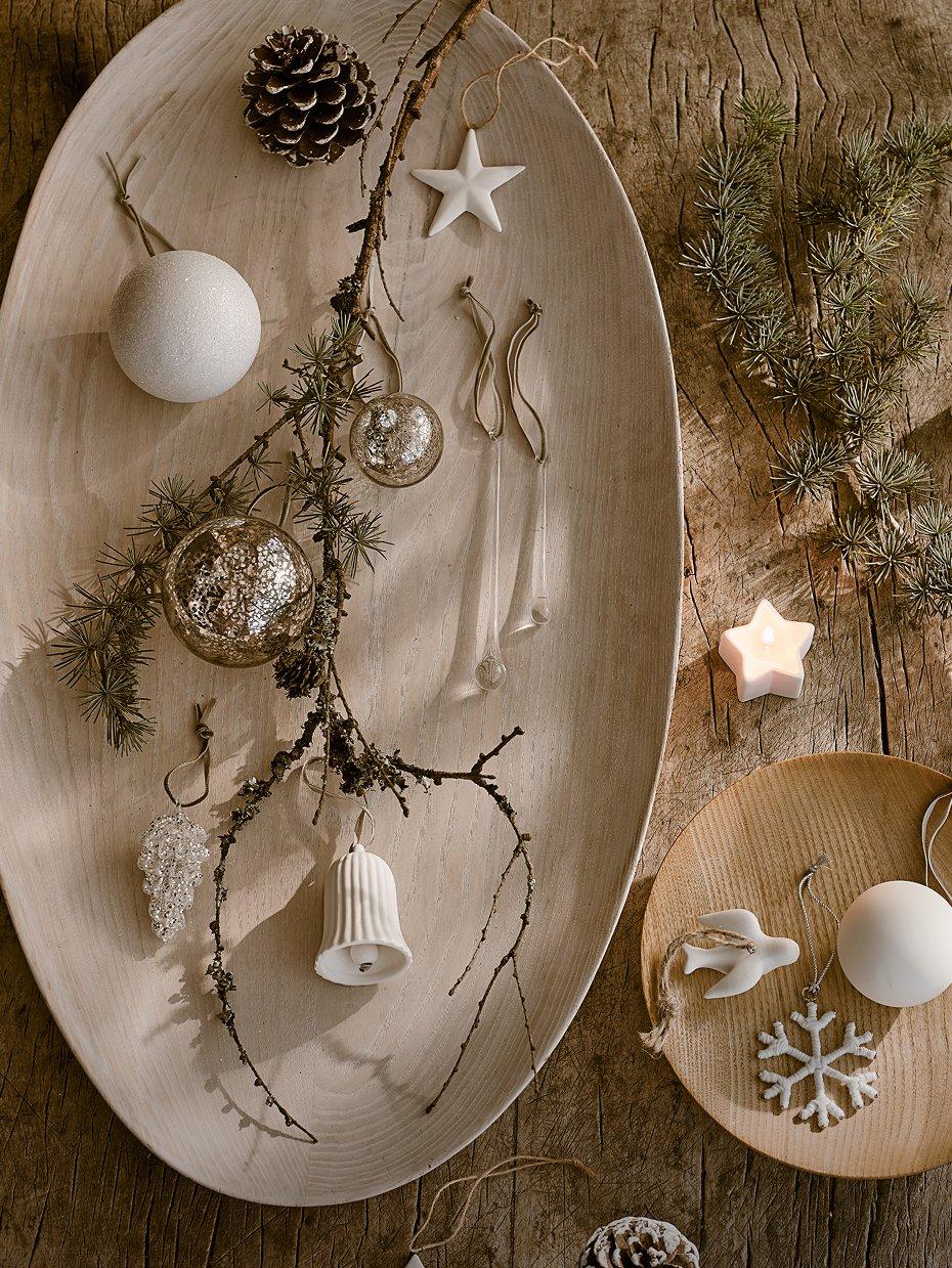 a wooden table with a plate of decorations on it