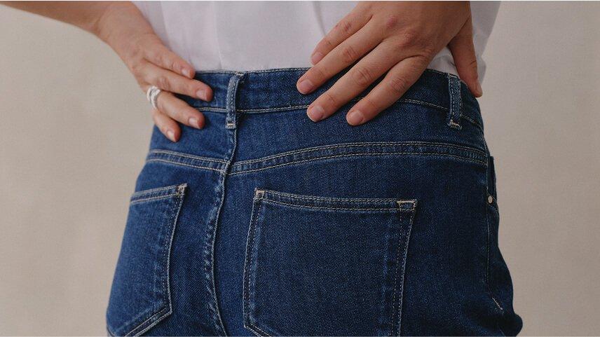 a woman is holding a pillow over her head and shoulders