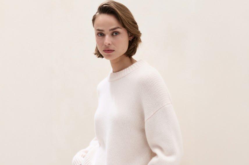 two women are wearing sweaters and one is wearing a scarf