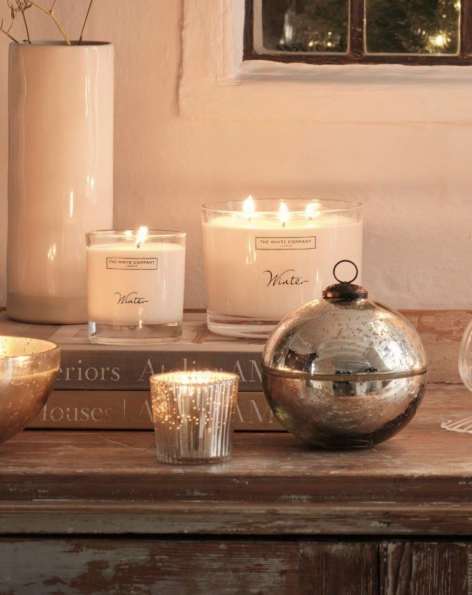 a wooden table with candles and other items on it