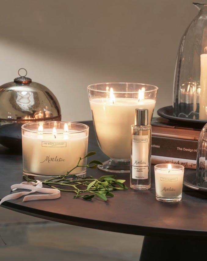 a table with candles and other items on it sitting on a table