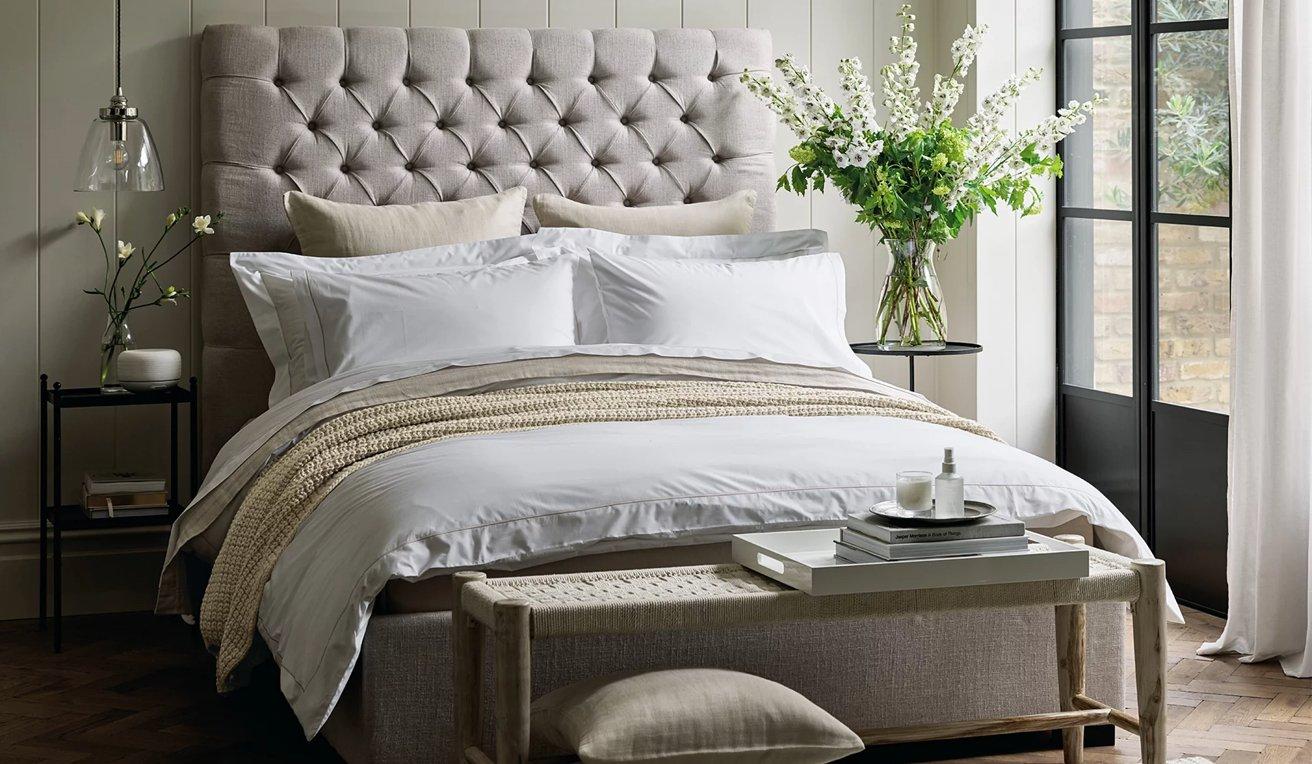 bed made with white company bed linen