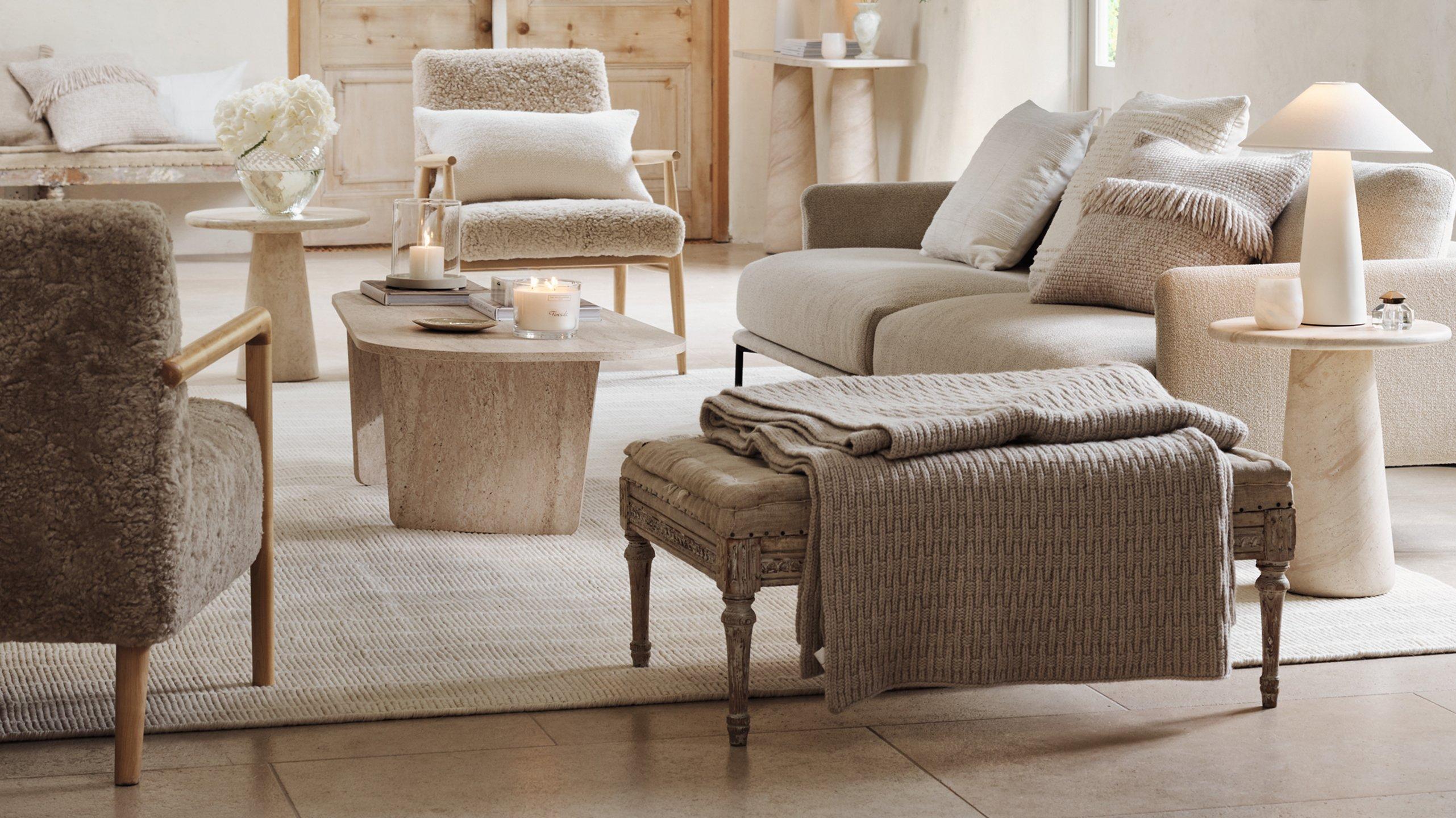a living room with a couch, chair, table and lamp