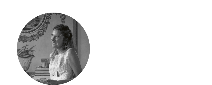 a woman in a white dress smiling at the camera