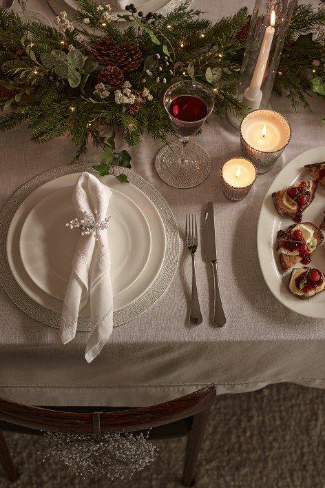 a white plate with a green napkin on it next to a green plate with a green nap