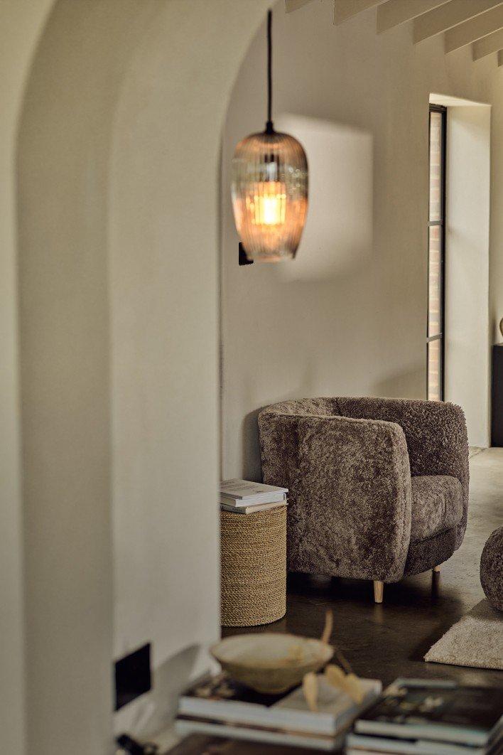 a living room with a couch, chair, and a lamp