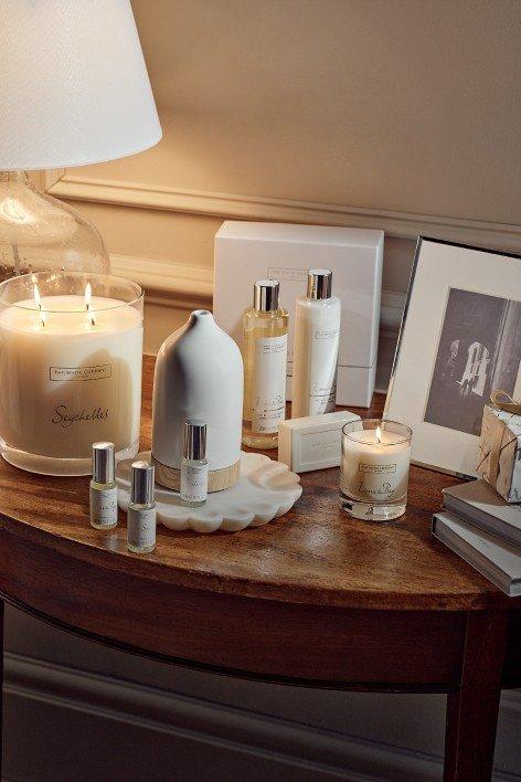 a bathroom counter with a white bag and a bottle of lotion