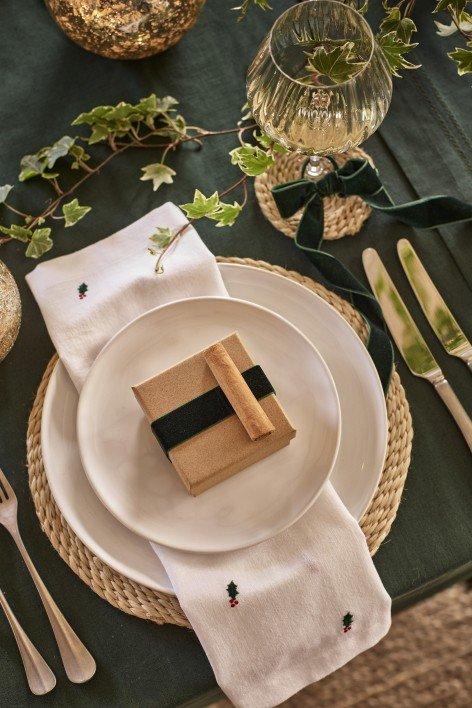 a white plate with a green napkin on it next to a green plate with a green nap