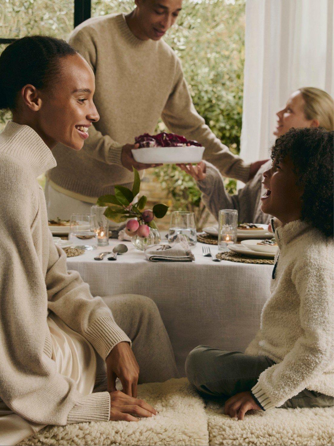 a bottle of essential oil and a reed diffuser on a table