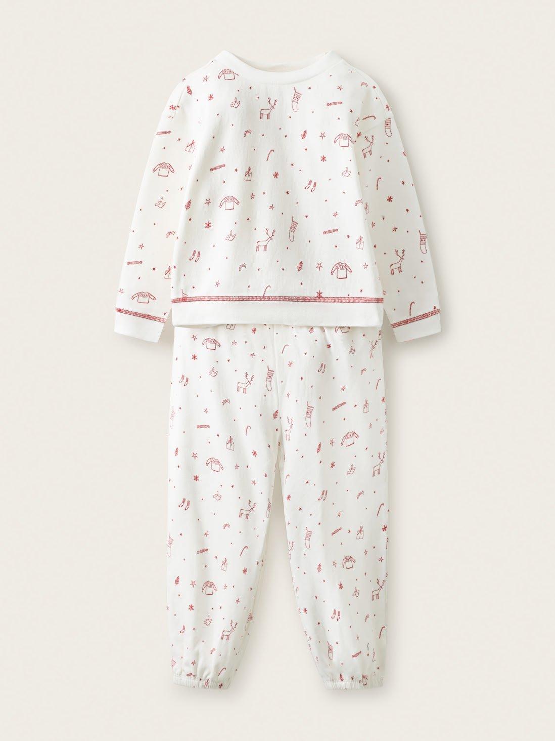 a baby's pajamas with pink and white animals on it