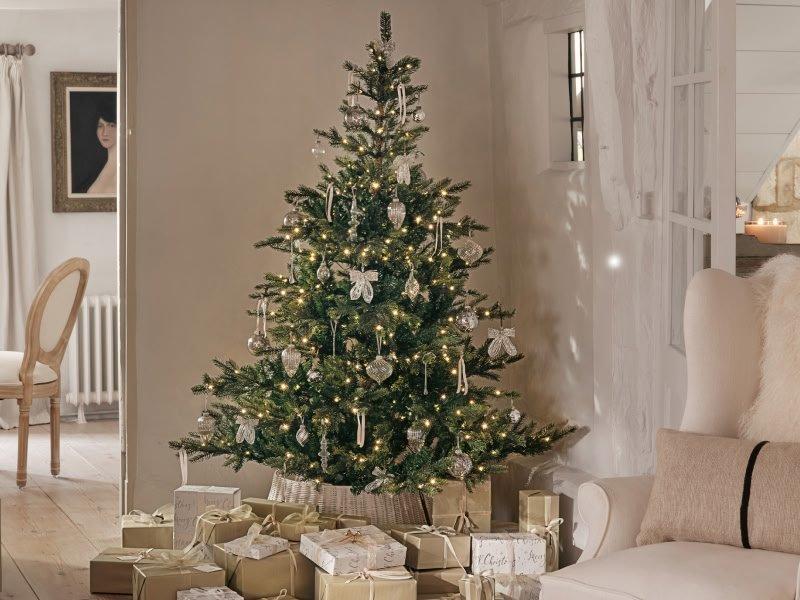 a living room with a christmas tree and presents under it