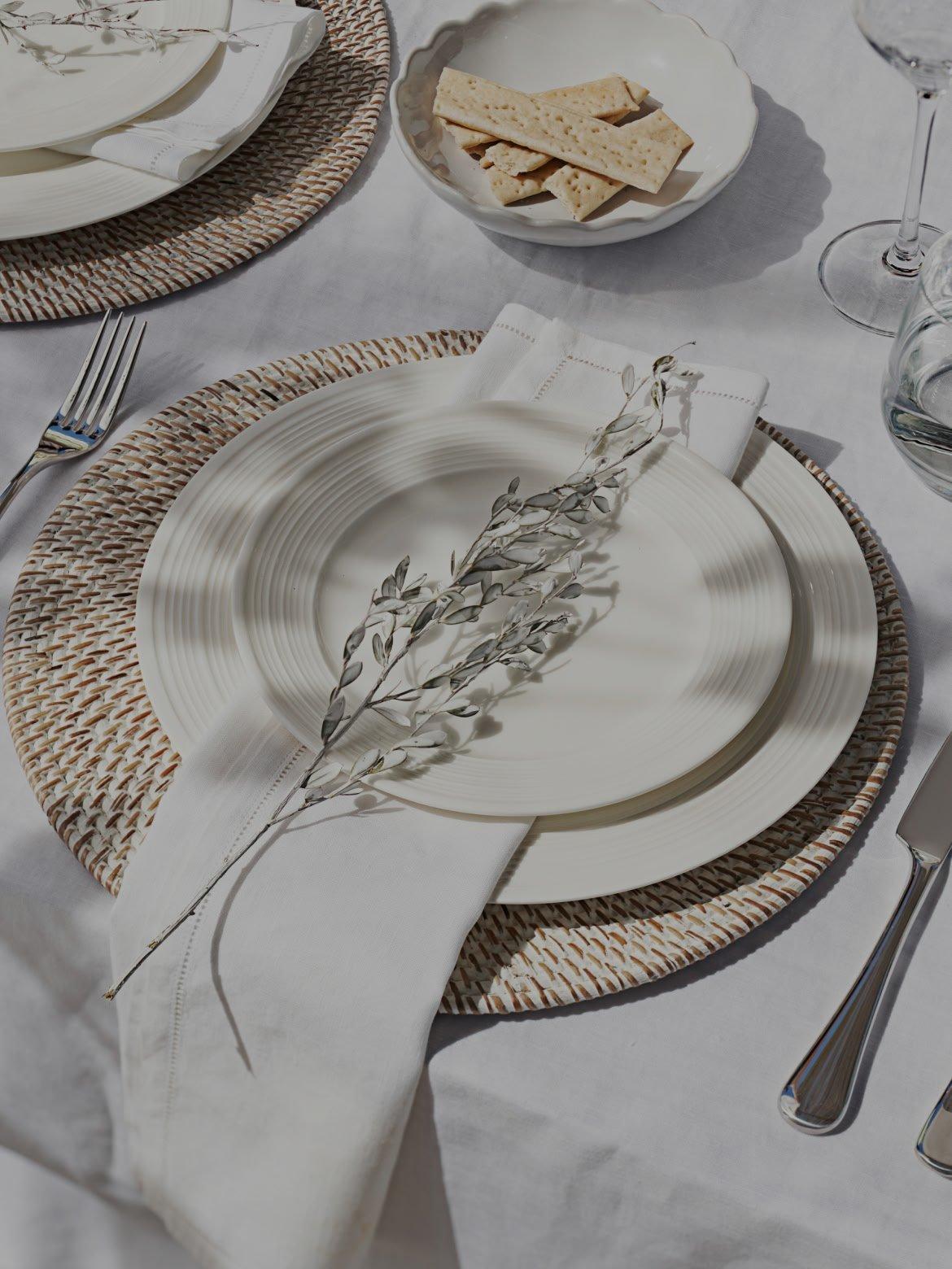 a white plate with a fork and knife on it next to a silverware set