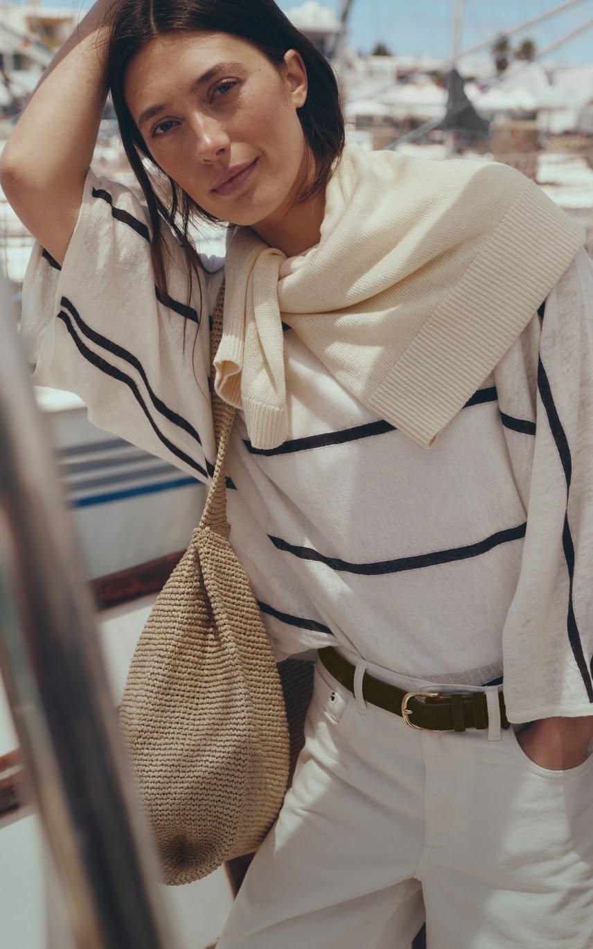a woman in a white shirt and scarf on a boat