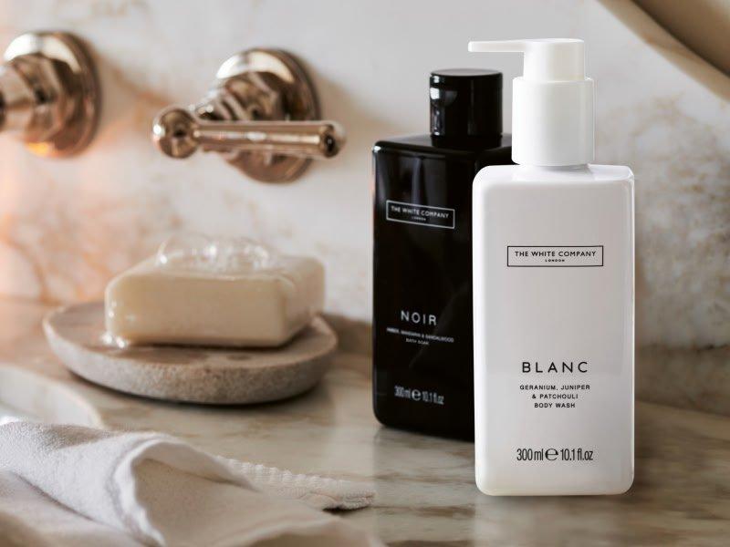 a bathroom counter with a bottle of body wash and soap