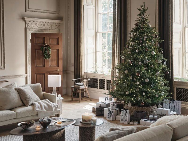 a living room with a christmas tree in it and a couch
