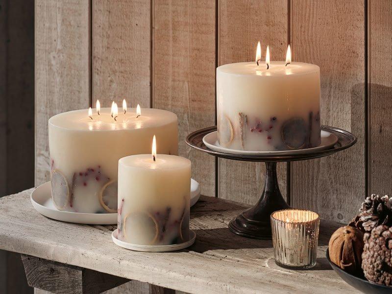 a table with candles and pine cones on it