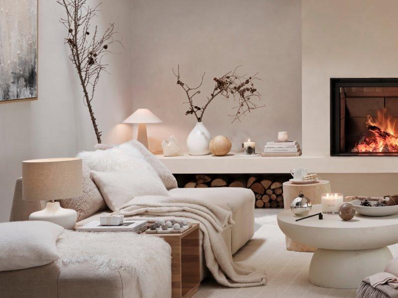 a living room with a fireplace and a couch and a table