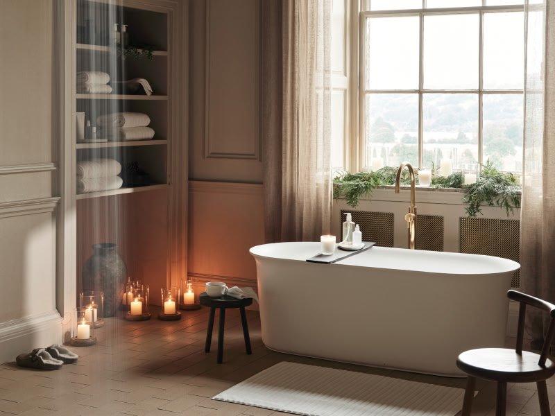 a bathroom with a bathtub and candles in the corner
