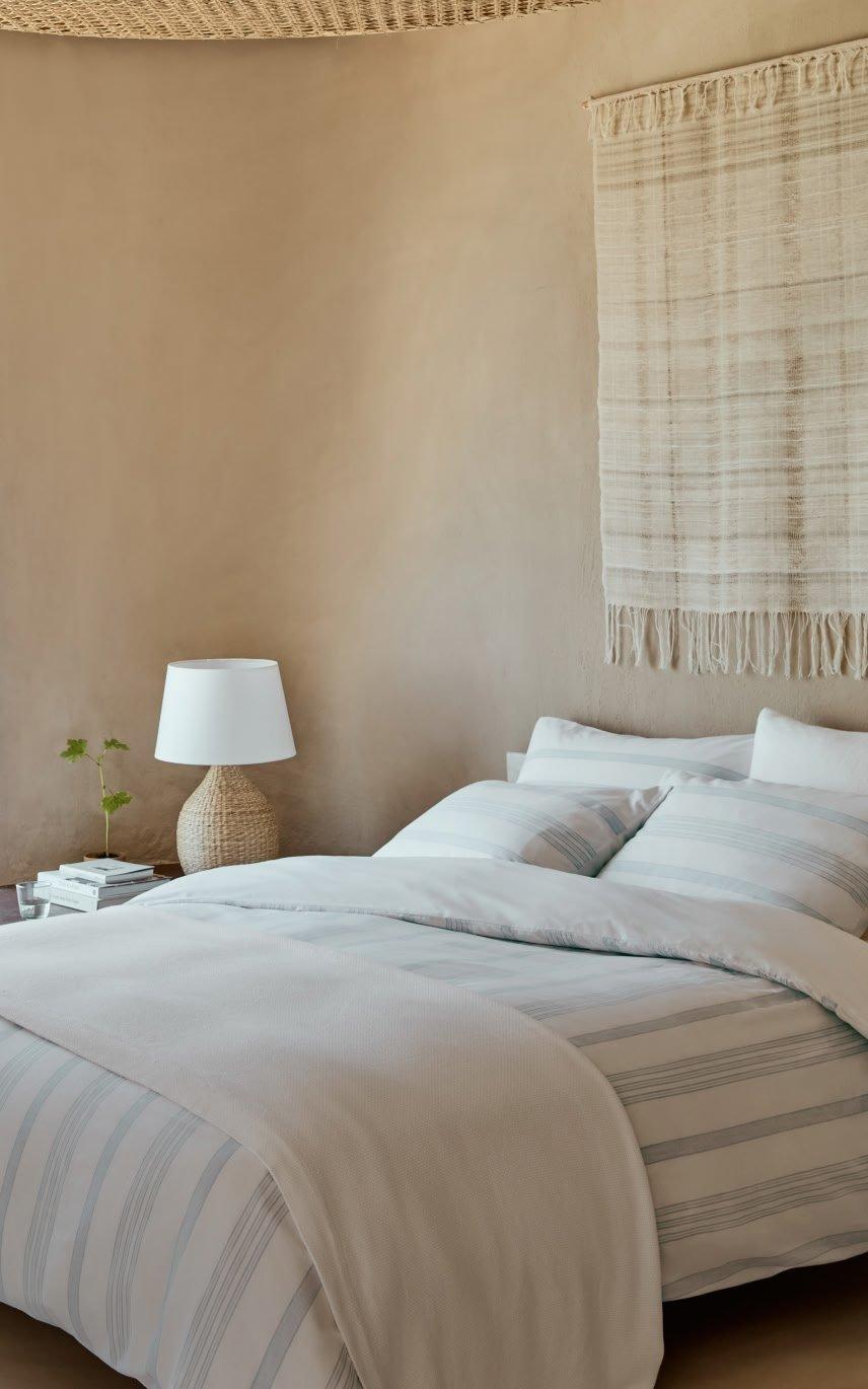 a bedroom with a large window overlooking the ocean and a bed