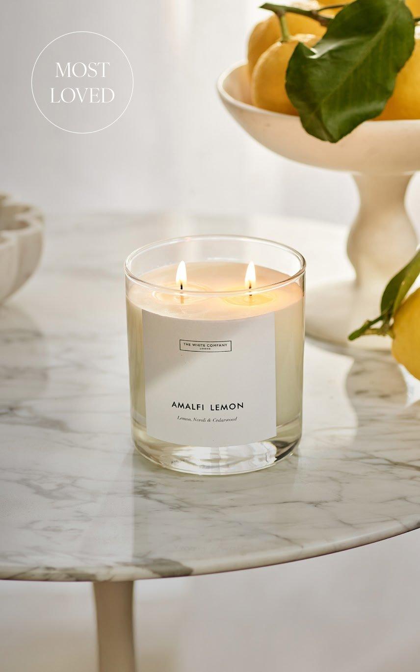 a table with a candle and some lemons on it
