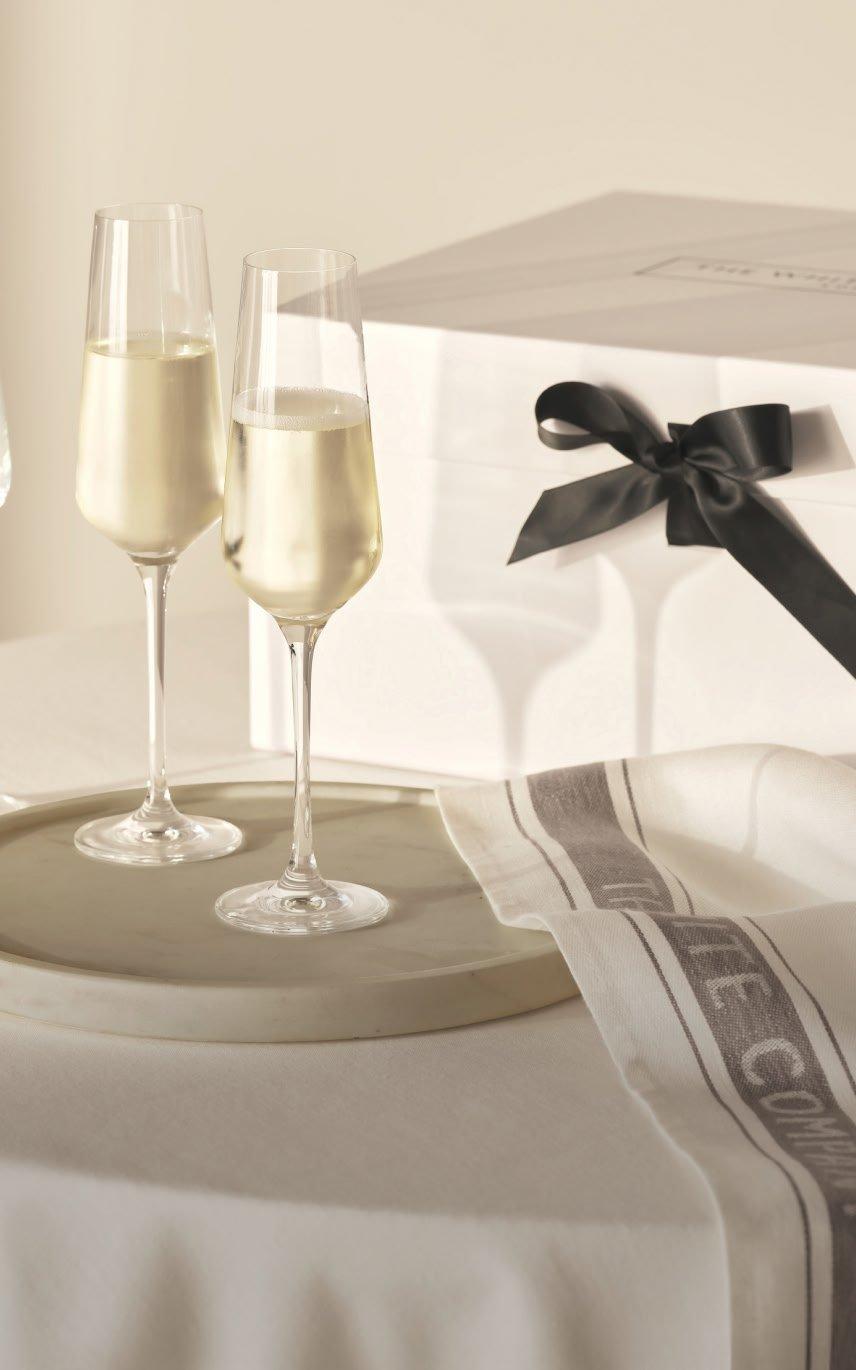 a table with a white cloth and a box with champagne glasses