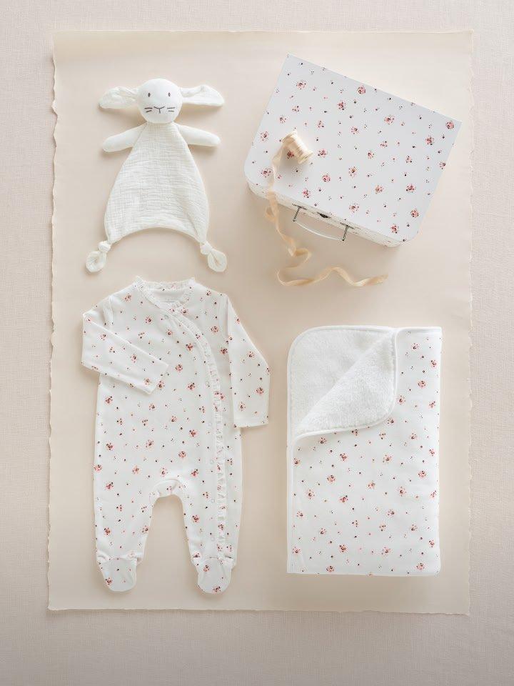 a white baby blanket, a baby hat, a baby hat, a baby blanket, a baby