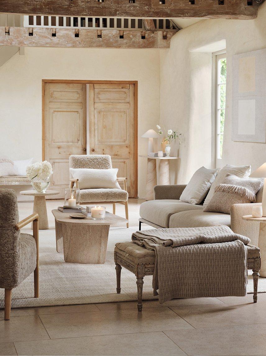 a living room with a couch, chair, table and lamp