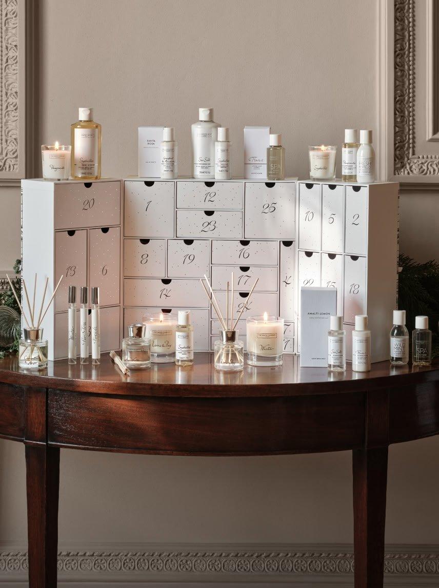 a table with a wooden top and a white box with candles