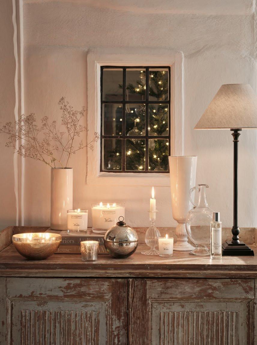 a table with candles, vases, and other decorative items on it