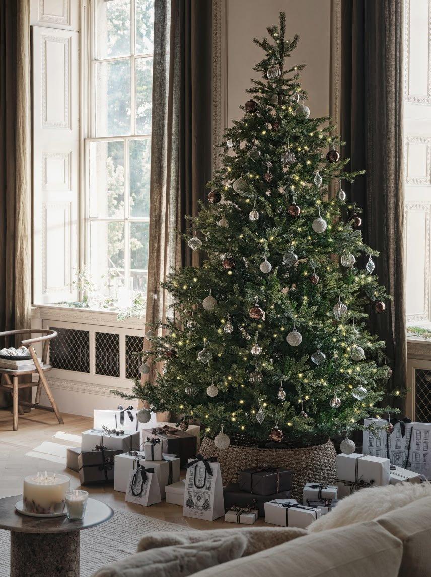 a living room with a christmas tree in it and a couch