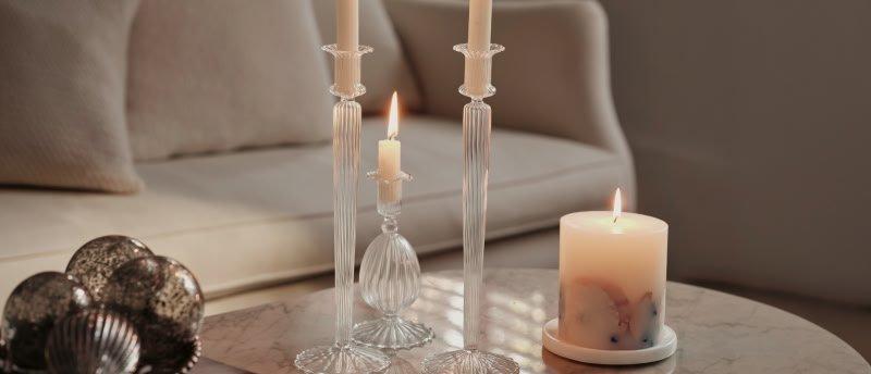 a table with three candles and a candle holder on it