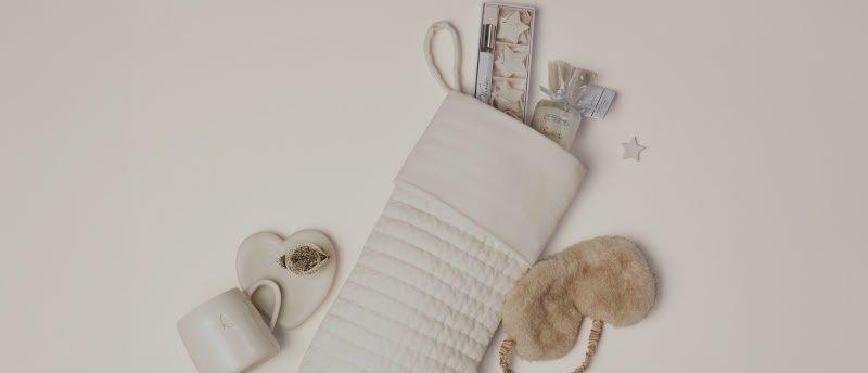 a white stocking with a bow and a gift on top