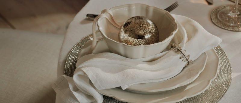 a white plate with silverware and a bowl on a white plate