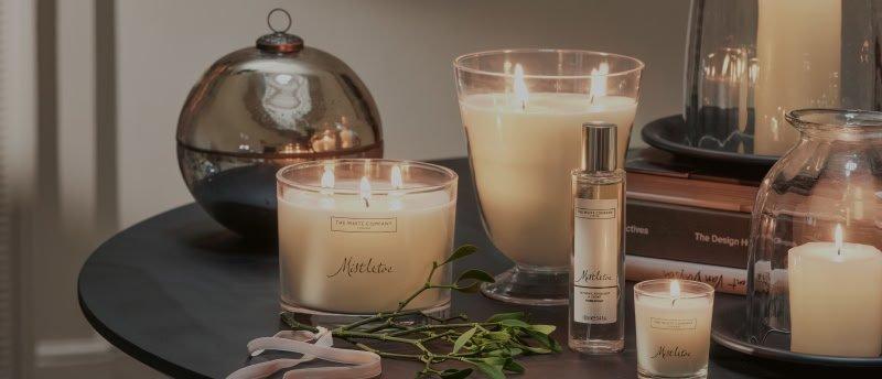a table with candles and other items on it, including a book