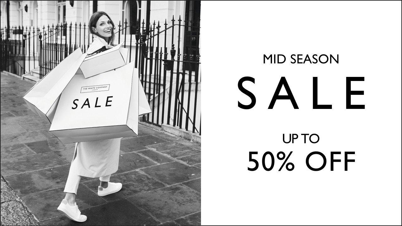 a black and white photo of a white bag with a sale sign