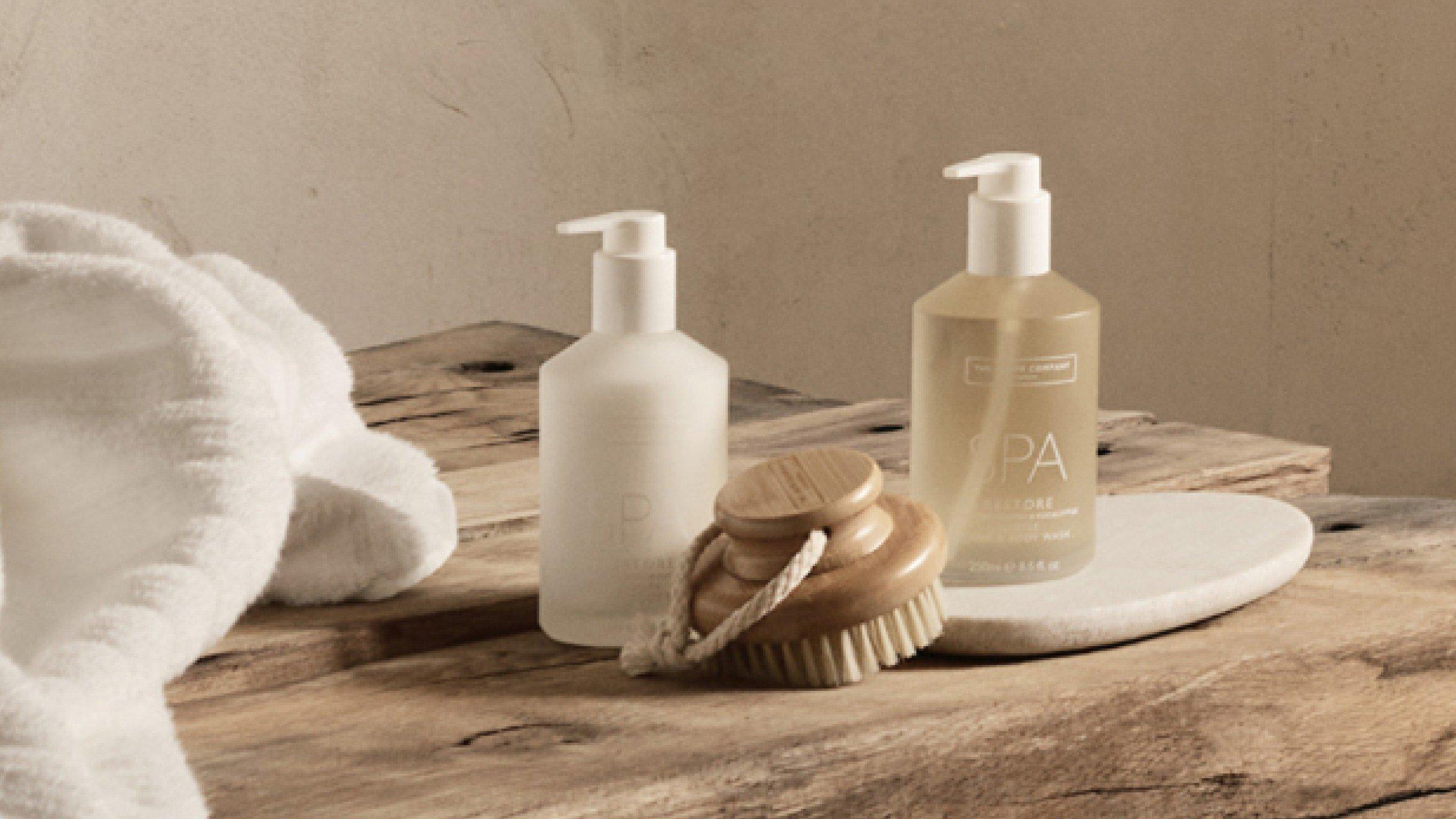 a wooden table with a bottle of lotion and a bottle of shampoo
