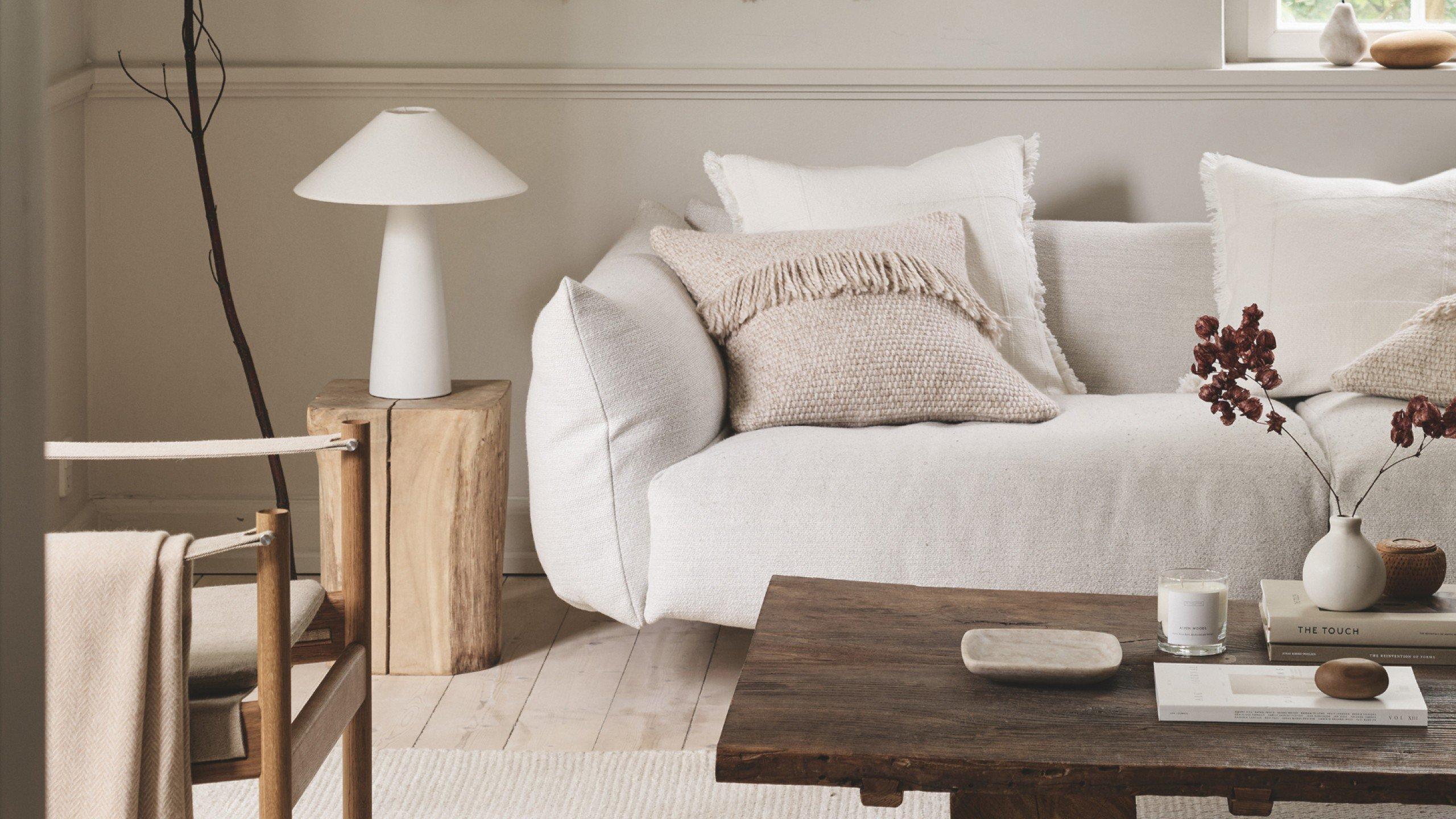a living room with a white couch and a coffee table