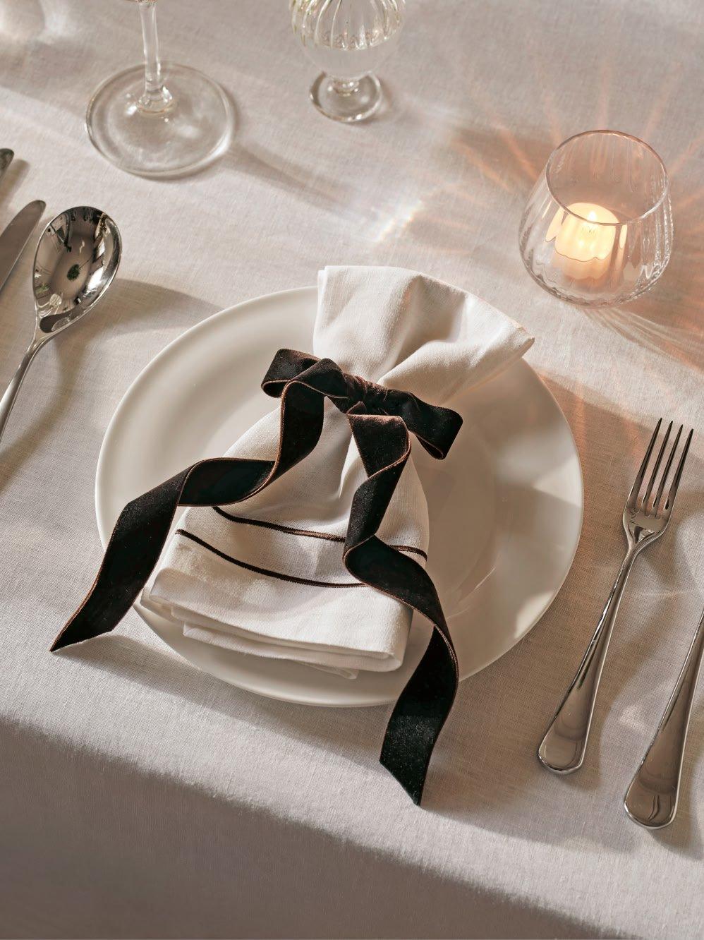 a white plate with a black and white napkin on it