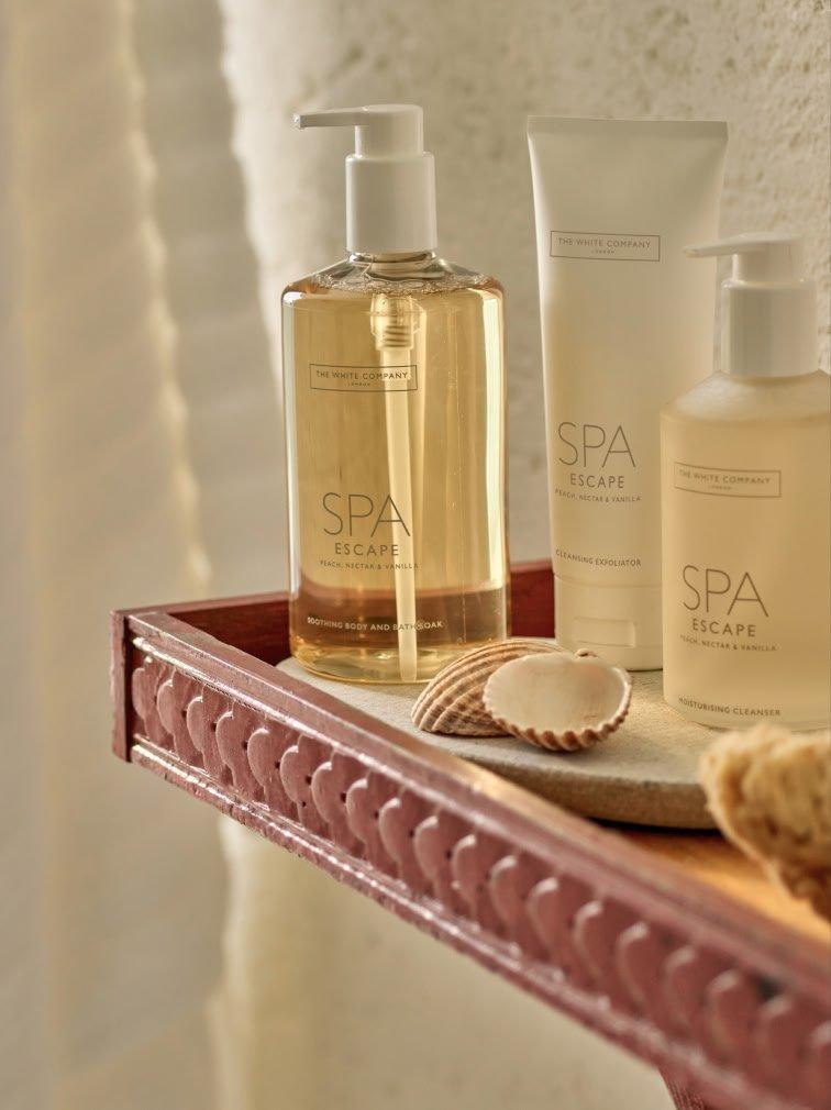 a shelf with a variety of spa products on it next to a shell