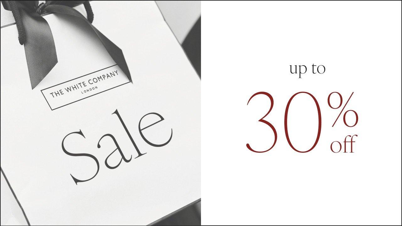 a white box with a black ribbon and a sign that says 30 % off
