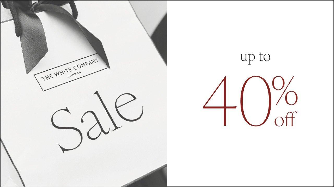 a white box with a black ribbon and a sign that says 40 % off